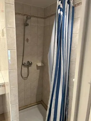 a shower with a blue shower curtain in a bathroom at Nature stay, French Villa in Villarzel-du-Razès