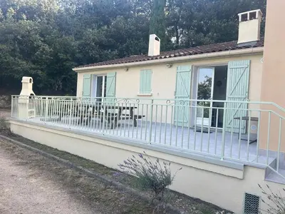 a house with a balcony with a table on it at Nature stay, French Villa in Villarzel-du-Razès