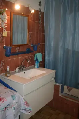 a bathroom with a sink and a mirror at Port La Nouvelle T2 rez de chaussée idéal pour 4 personnes in Port-la-Nouvelle