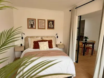 a bedroom with a bed and a plant in a room at Peaceful & Elegant Retreat in the heart of town in Carcassonne
