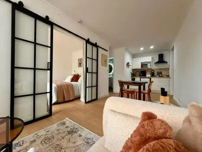 a living room with a couch and a table at Peaceful & Elegant Retreat in the heart of town in Carcassonne
