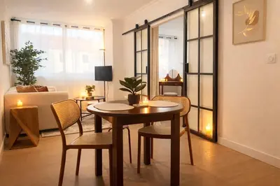 a living room with a table and chairs and a couch at Peaceful & Elegant Retreat in the heart of town in Carcassonne