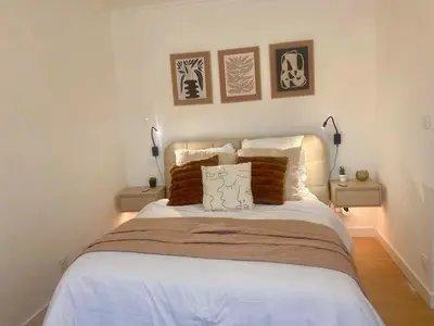 a bedroom with a bed with three pictures on the wall at Peaceful & Elegant Retreat in the heart of town in Carcassonne