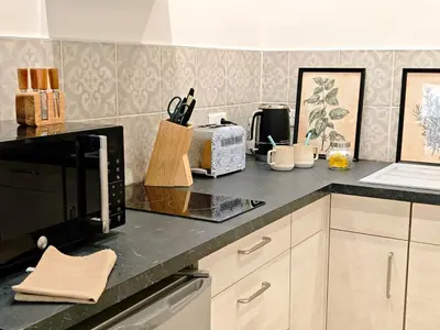 a kitchen with a counter top with a microwave at LE COSY - Studio 4 pers - wifi - centre ville in Limoux
