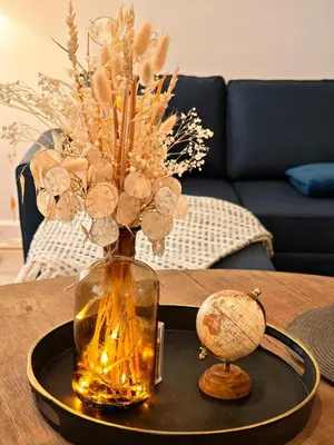 a vase with flowers in it on a table at LE COSY - Studio 4 pers - wifi - centre ville in Limoux
