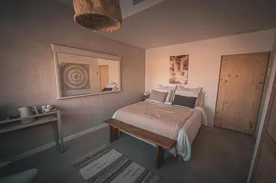 a bedroom with a bed with white sheets and a window at Les Rocheuse Treilles in Treilles