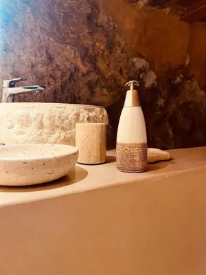 a counter with a sink and a bottle of soap at Escapade Troglodyte in Fitou
