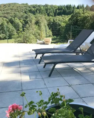 two lounge chairs sitting on top of a patio at Old Farmhouse Surrounded By Nature In Sidobre in Burlats