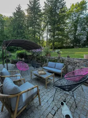 a patio with chairs and a couch and a table at Old Farmhouse Surrounded By Nature In Sidobre in Burlats