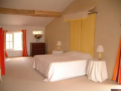 a bedroom with a white bed and two tables at La Bomba Is A Stunning Farmhouse in Glorious Countryside With Private Pool in Saint-Paulet