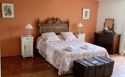a bedroom with a large bed and two night stands at La Bomba Is A Stunning Farmhouse in Glorious Countryside With Private Pool in Saint-Paulet