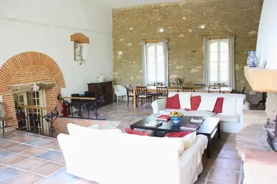 a living room with white couches and a brick wall at La Bomba Is A Stunning Farmhouse in Glorious Countryside With Private Pool in Saint-Paulet