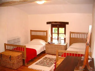 a bedroom with two beds and a table at La Bomba Is A Stunning Farmhouse in Glorious Countryside With Private Pool in Saint-Paulet