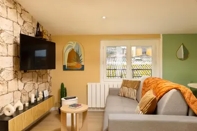 a living room with a table with fruit on it at Cap color-Parking public gratuit-4 guests-centre-ville in Limoux