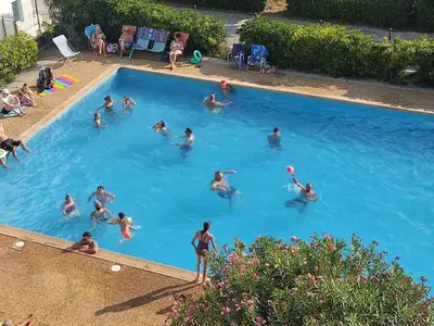 a group of people swimming in a swimming pool at Appartement T2 à Gruissan - Piscine & Parking, 2/3 Pers. - FR-1-796-107 in Gruissan