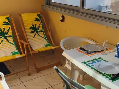 a dining room with a table and a table and chairs at Appartement T2 à Gruissan - Piscine & Parking, 2/3 Pers. - FR-1-796-107 in Gruissan