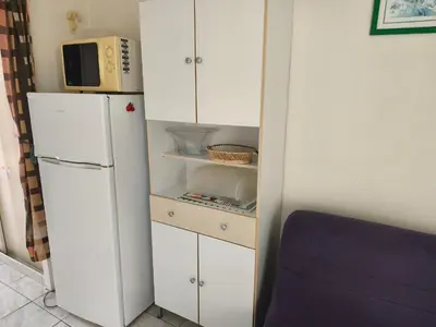 a kitchen with a white refrigerator and a microwave at Appartement T2 à Gruissan - Piscine & Parking, 2/3 Pers. - FR-1-796-107 in Gruissan