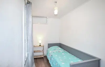 a small bedroom with a bed and a night stand at Authentique Maison Piscine in Saint-Amans-Valtoret