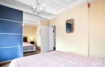a bedroom with a bed and a blue wall at Authentique Maison Piscine in Saint-Amans-Valtoret