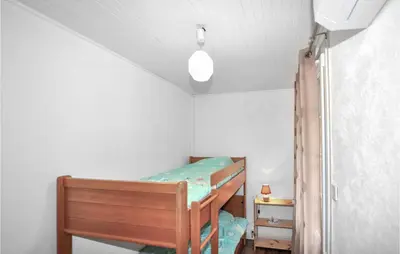 a bedroom with two bunk beds and a ceiling at Authentique Maison Piscine in Saint-Amans-Valtoret