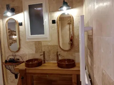 a bedroom with a bed and wooden walls at chambre et table d'hôtes Au coin de la cité 2 in Carcassonne