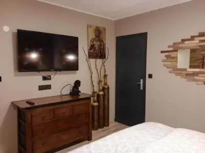a bedroom with a bed with a wooden wall at chambre et table d'hôtes Au coin de la cité 2 in Carcassonne