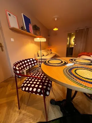 a bedroom with a bed and a red rug at Appartement La voisine de Charles in Narbonne