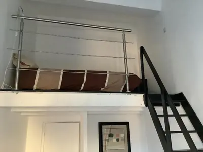 a bedroom with a bunk bed on a ladder at La planque in Gruissan