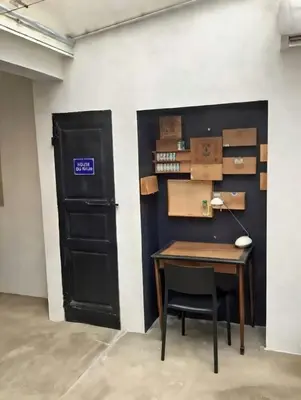 a room with a table and a door with boxes at La planque in Gruissan