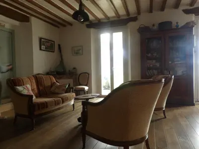 a living room with a couch and a chair at Mas cantecou in Mosset