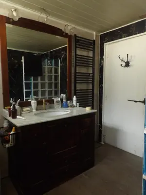 a bathroom with a sink and a large mirror at Mas cantecou in Mosset