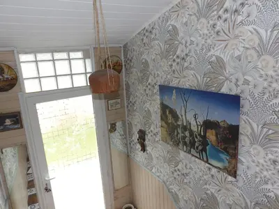 a room with a painting on the wall and a window at Mas cantecou in Mosset