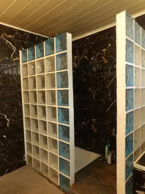 a wall of glass blockades in a room with a counter at Mas cantecou in Mosset