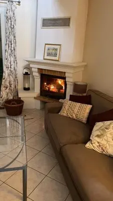 a living room with a couch and a fireplace at Villa Lana in Verzeille