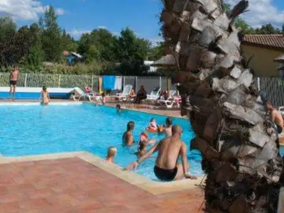 a group of people in a swimming pool at Chalet Confort avec Terrasse - 4 Personnes - API-1-52-1742 in Villegly