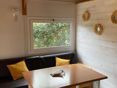 a dining room with a table and a window at Chalet Confort avec Terrasse - 4 Personnes - API-1-52-1742 in Villegly