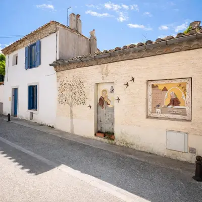 a building with a mural on the side of it at La Lodge des Remparts View and Private Patio in Carcassonne