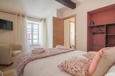 a bedroom with a large bed with two pillows on it at La Lodge des Remparts View and Private Patio in Carcassonne