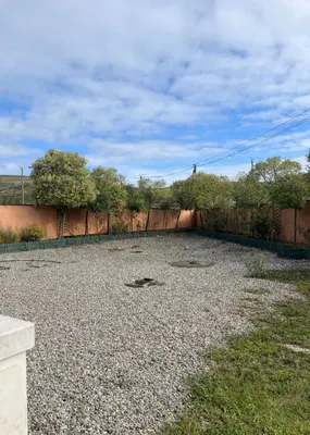 an empty yard with a fence and trees at Las Mijeannos in Cazalrenoux