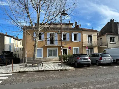 a street with cars parked in front of a house at Spacious house in the center of Quillan in Quillan