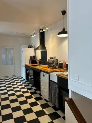 a kitchen with a black and white checkered floor at Spacious house in the center of Quillan in Quillan