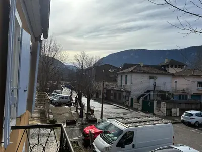 a white van parked in a parking lot next to a house at Spacious house in the center of Quillan in Quillan