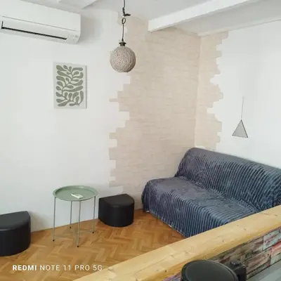 a living room with a couch and a table at Charmant T2 de 43 m2 in Port-la-Nouvelle