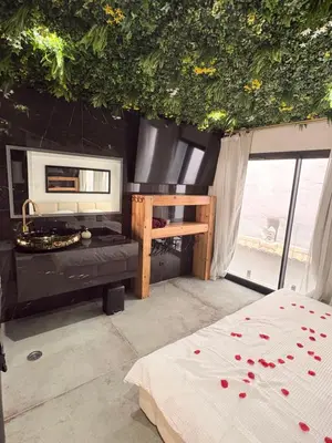 a bedroom with a bed and a large window at Love Room végétale n102 in Narbonne