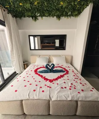 a bed with a heart made out of red flowers at Love Room végétale n102 in Narbonne