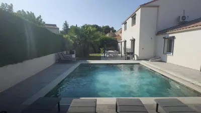 a swimming pool in the backyard of a house at Villa Élégance in Peyriac-de-Mer