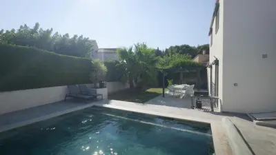 a swimming pool in the backyard of a house at Villa Élégance in Peyriac-de-Mer
