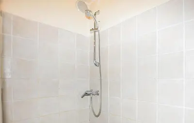 a shower with a shower head in a bathroom at Maison Piscine Proche Mer in Portel-des-Corbières
