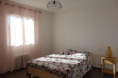 a bedroom with a bed and a window at La Cesse in Bize-Minervois
