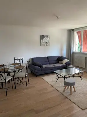 a living room with a couch and a table at Maison T4 dans ancien corps de ferme avec lac in Gaudiès